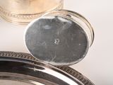 a silver plate with a silver lid and a silver cup