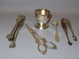 a lot of silver spoons and other silverware on a table