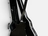 a guitar and a guitar case on a white surface