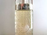 an image of a bottle of perfume sitting on a table