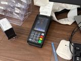 a cell phone sitting on a desk next to a keyboard