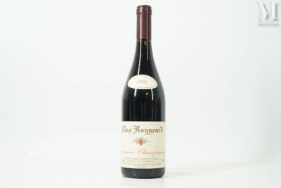 the bottle of red wine is sitting on the table