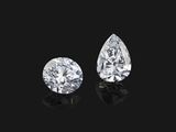 a pair of pear shaped diamonds on a black background