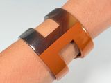 brown and black cuff bracelet with a brown and black design on it