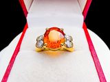 an image of a ring in a box with a red ribbon around it
