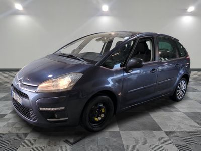a picture of a small blue car parked in a garage