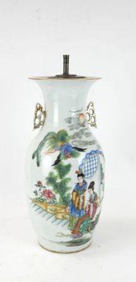 a white vase with a painting on it on a white surface