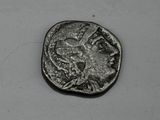 une pièce d'argent sur laquelle figure une tête de femme