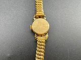 a gold watch with a chain around it