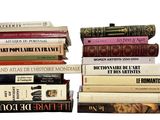 many books stacked on top of each other on a table