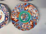 three plates with designs on them are sitting on a table
