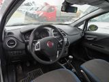dashboard view of a small car with a steering wheel and dashboard controls