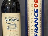 a bottle of wine sitting next to a box on a table