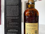 an image of a bottle of whisky sitting next to a box on a table