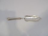 a silver spoon with a handle on a white surface