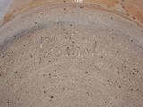 a close up of a brown vase with writing on it