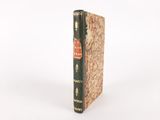 a close up of a book sitting on top of a white surface