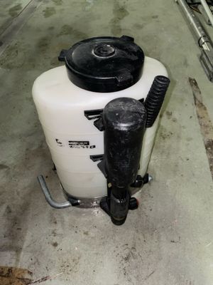 a white tank with a black lid and a black handle