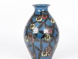 a blue vase with a floral design on it