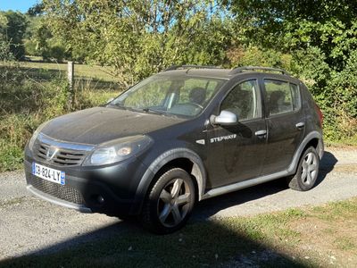 a small black car parked on the side of the road
