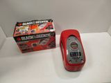 a red cell phone sitting next to a black and decker box