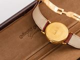 a watch in a case that is open on the table