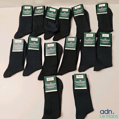 six pairs of men ' s black dress socks with labels on them