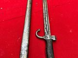 two old swords are sitting on a red surface