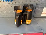 two black and orange trash cans sitting on a shelf