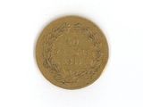 une pièce d'or sur une surface blanche avec un fond blanc