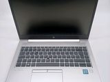 an open laptop computer sitting on top of a white table