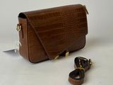 brown leather cross body bag with gold hardware and strap