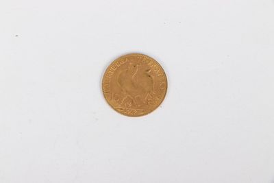 a close up of a gold coin on a white surface