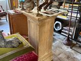 a statue of a horse on a pedestal in the middle of a room