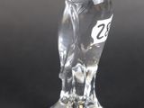 clear glass figurine of an owl on a black background