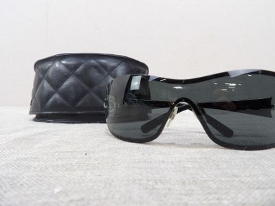 a pair of sunglasses sitting on a table next to a purse