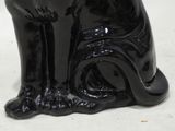 a black cat statue that is sitting on a table