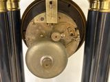 an image of a black and gold clock on a stand