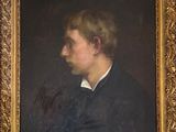 portrait of a man in a black coat and white collared shirt