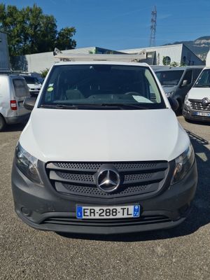 a white van parked in a parking lot next to other vehicles