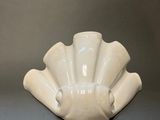 a white vase that is sitting on a table