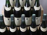 many bottles of wine in a wooden crate on a table
