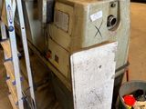 a machine that is sitting inside of a building next to a trash can