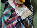 a lot of ties that are laying on a bed