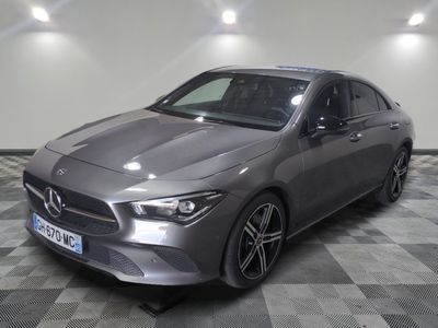 the mercedes cla is parked on a checkered floor in a garage