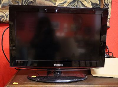 a flat screen tv sitting on top of a wooden table