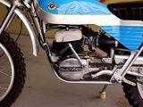 a blue and white motorcycle parked in a garage