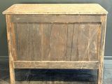 an old wooden chest sitting on top of a floor next to a wall