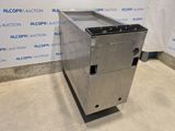 a metal box with a metal lid sitting on top of a floor