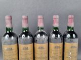 four bottles of wine are lined up on a table
